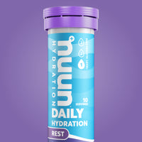 A tube of Nuun Rest on a purple background.